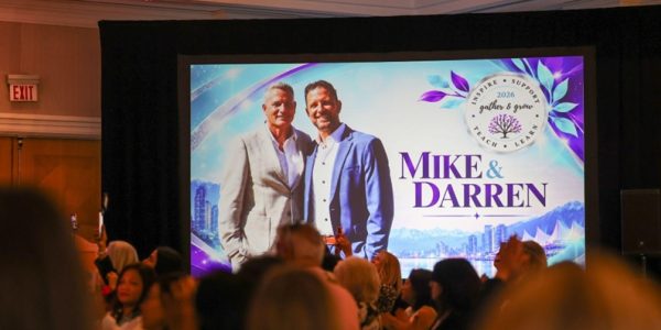 Audience watching a screen that shows Darren and Mike at the Dream Team Gather and Grow 2026 in Vancouver