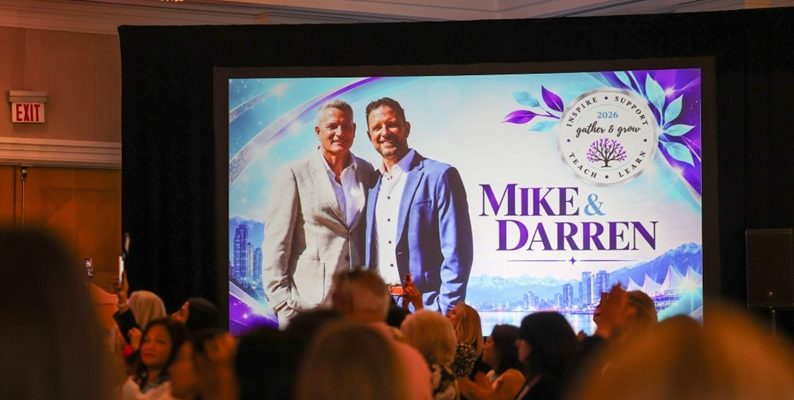 Audience watching a screen that shows Darren and Mike at the Dream Team Gather and Grow 2026 in Vancouver
