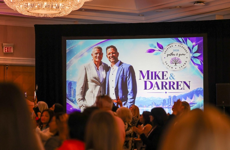 Audience watching a screen that shows Darren and Mike at the Dream Team Gather and Grow 2026 in Vancouver